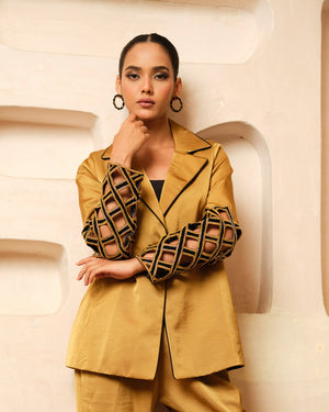Crafted from luxurious Imported Satin, this elegant Blazer Co-ord Set features intricately designed cutwork sleeves accentuated with exquisite hand embroidery for a rich, dimensional finish. The blazer is further elevated with contrast piping on the collar, adding a refined touch to its tailored silhouette. A perfect blend of contemporary sophistication and artisanal craftsmanship, this ensemble is ideal for festive occasions, evening events, and power dressing