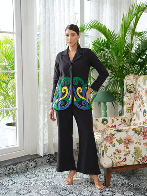 Crafted in cotton handloom fabric, this shirt features intricate appliqué work in vibrant pink, blue, and orange swirls, enhanced with delicate hand embroidery and silver cut and pearl detailing. Designed with a tailored silhouette, it blends artisanal craftsmanship with effortless sophistication.