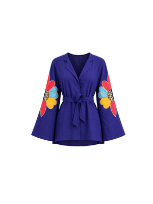 Part of the Heavenly Hues collection, this statement top is a masterpiece adorned with meticulously crafted fabric appliqué flowers, delicately framed by intricate zardosi borders. The floral motifs are elevated with exquisite cutwork detailing that adds depth, texture, and sophistication. Designed with a contemporary notch lapel and elegant bell sleeves, the silhouette blends timeless craftsmanship with modern refinement. A celebration of floral artistry and graceful design.