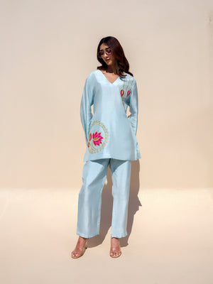The Nirvana Lotus top beautifully redefines elegance with its dreamy pastel hues and intricate golden detailing. Handcrafted lotus motifs adorn the design, adding a touch of artistry and sophistication that makes it a true standout piece. Blending luxurious craftsmanship with effortless charm, this statement piece embodies timeless grace and contemporary style, making it perfect for festive gatherings and special occasions.
