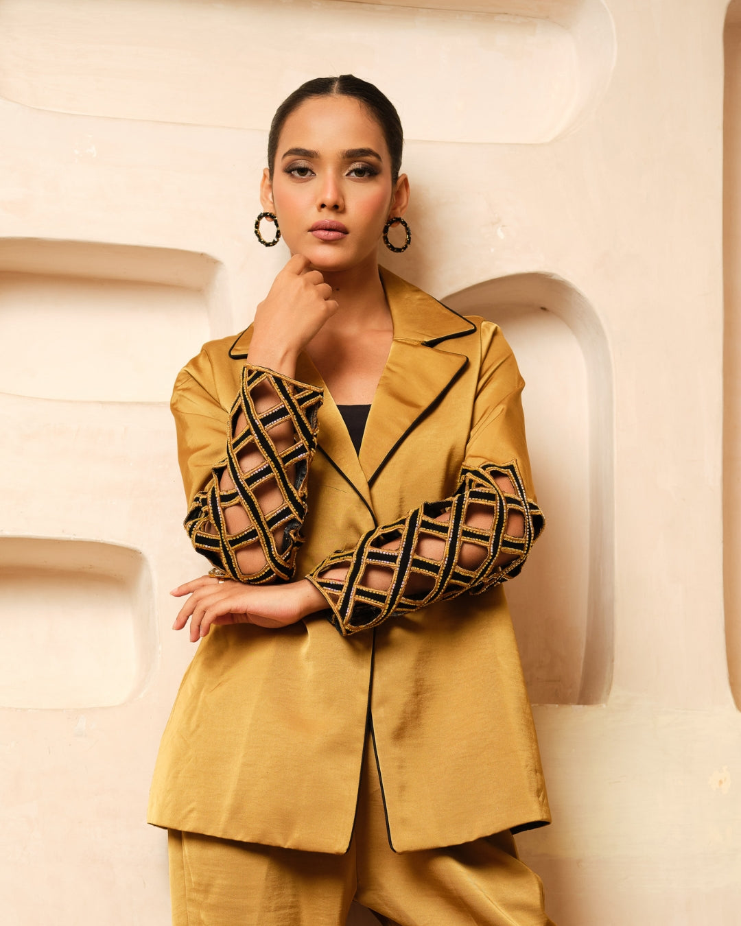 Crafted from luxurious Imported Satin, this elegant Blazer Co-ord Set features intricately designed cutwork sleeves accentuated with exquisite hand embroidery for a rich, dimensional finish. The blazer is further elevated with contrast piping on the collar, adding a refined touch to its tailored silhouette. A perfect blend of contemporary sophistication and artisanal craftsmanship, this ensemble is ideal for festive occasions, evening events, and power dressing