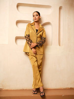 Crafted from luxurious Imported Satin, this elegant Blazer Co-ord Set features intricately designed cutwork sleeves accentuated with exquisite hand embroidery for a rich, dimensional finish. The blazer is further elevated with contrast piping on the collar, adding a refined touch to its tailored silhouette. A perfect blend of contemporary sophistication and artisanal craftsmanship, this ensemble is ideal for festive occasions, evening events, and power dressing