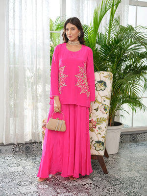 This refined top is tailored in luxurious crepe fabric, adorned with intricate embroidery and hand embellishments. Accented with golden zari and delicate kadhana work, the design embodies timeless artistry with a contemporary edge. The detailing extends gracefully across the sleeves, creating an elegant statement from every angle. An ode to effortless charm, this piece is crafted for the modern muse who embraces tradition with a touch of contemporary sophistication.