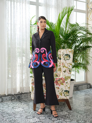 Crafted in cotton handloom fabric, this shirt features intricate appliqué work in vibrant pink, blue, and orange swirls, enhanced with delicate hand embroidery and silver cutdana pearl detailing. Designed with a tailored silhouette, it blends artisanal craftsmanship with effortless sophistication.