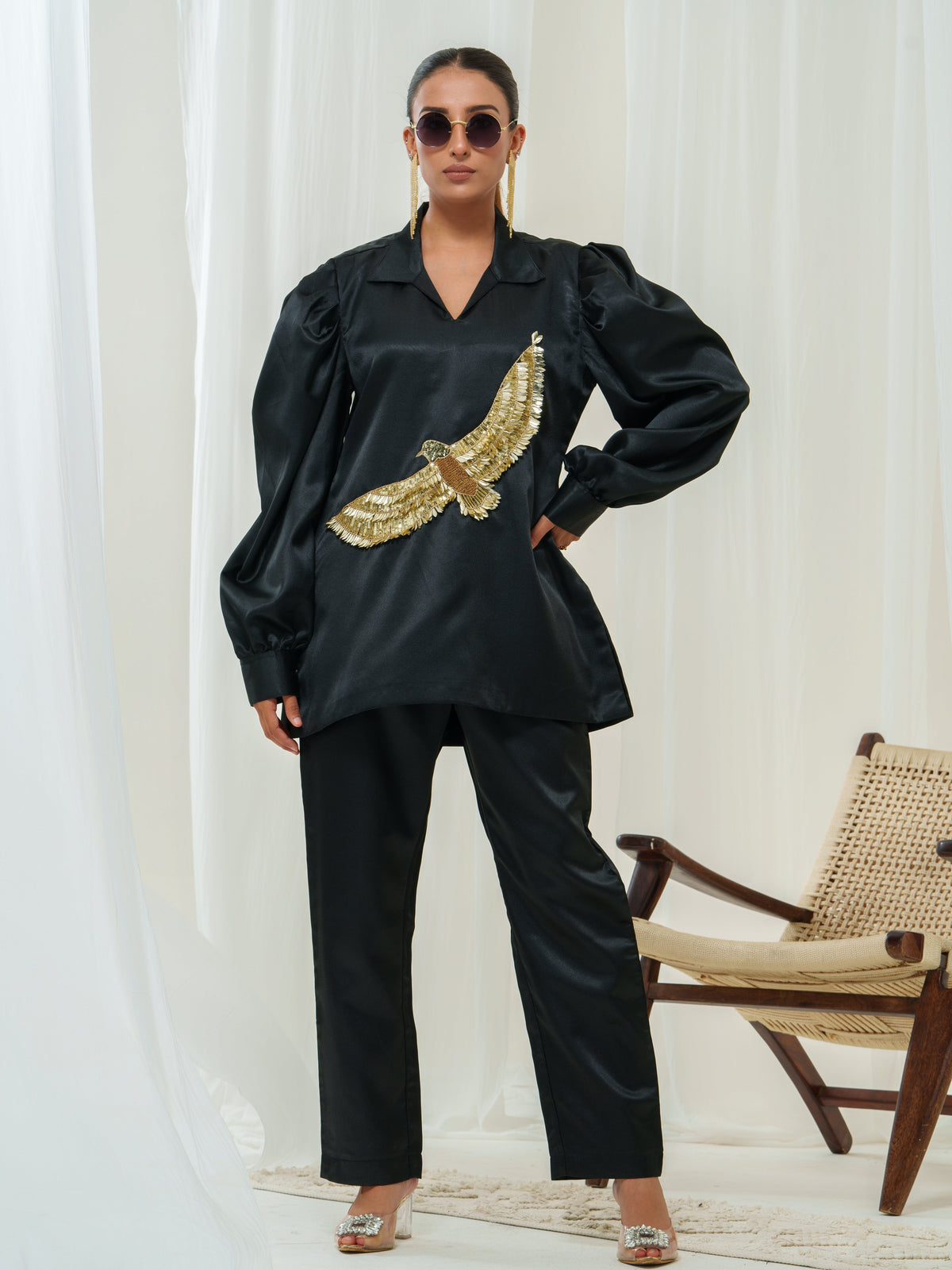 "Wingspan," a reflection of impeccable quality and timeless elegance. This co-ord set is crafted from the finest materials, ensuring a luxurious feel and comfort throughout wear. The highlight of this collection is the striking eagle patchwork, meticulously adorned with golden detailing, creating a regal and classy appeal.