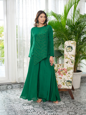 Step into effortless elegance with this uniquely designed top, crafted from high-quality crepe fabric known for its soft texture and graceful drape. The silhouette features an eye-catching asymmetrical cut, beautifully accented with metallic salli handwork&nbsp;and intricate embroidery that adds a touch of understated glamour. Blending contemporary design with refined craftsmanship, this piece is perfect for festive occasions, semi-formal events, and intimate gatherings.